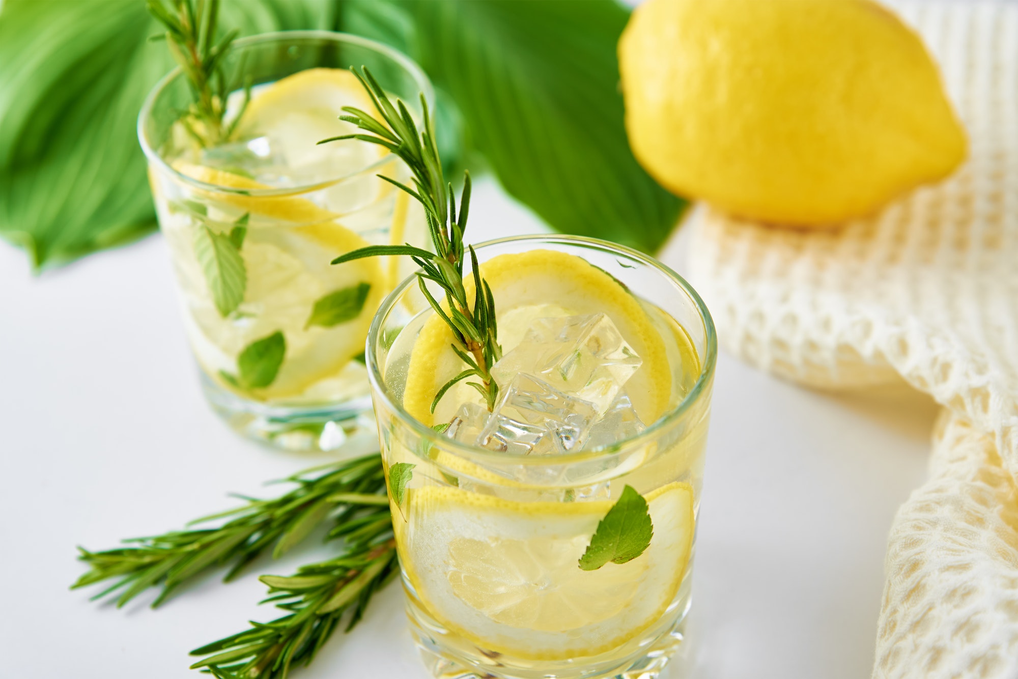 Drink with lemon and rosemary on table